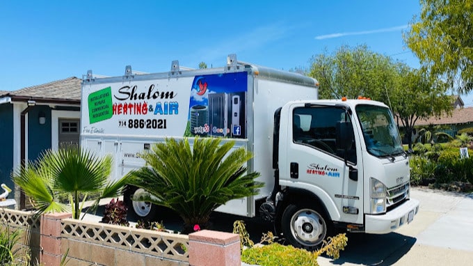2025-06-12 Shalom Heating and Air truck parked in driveway.