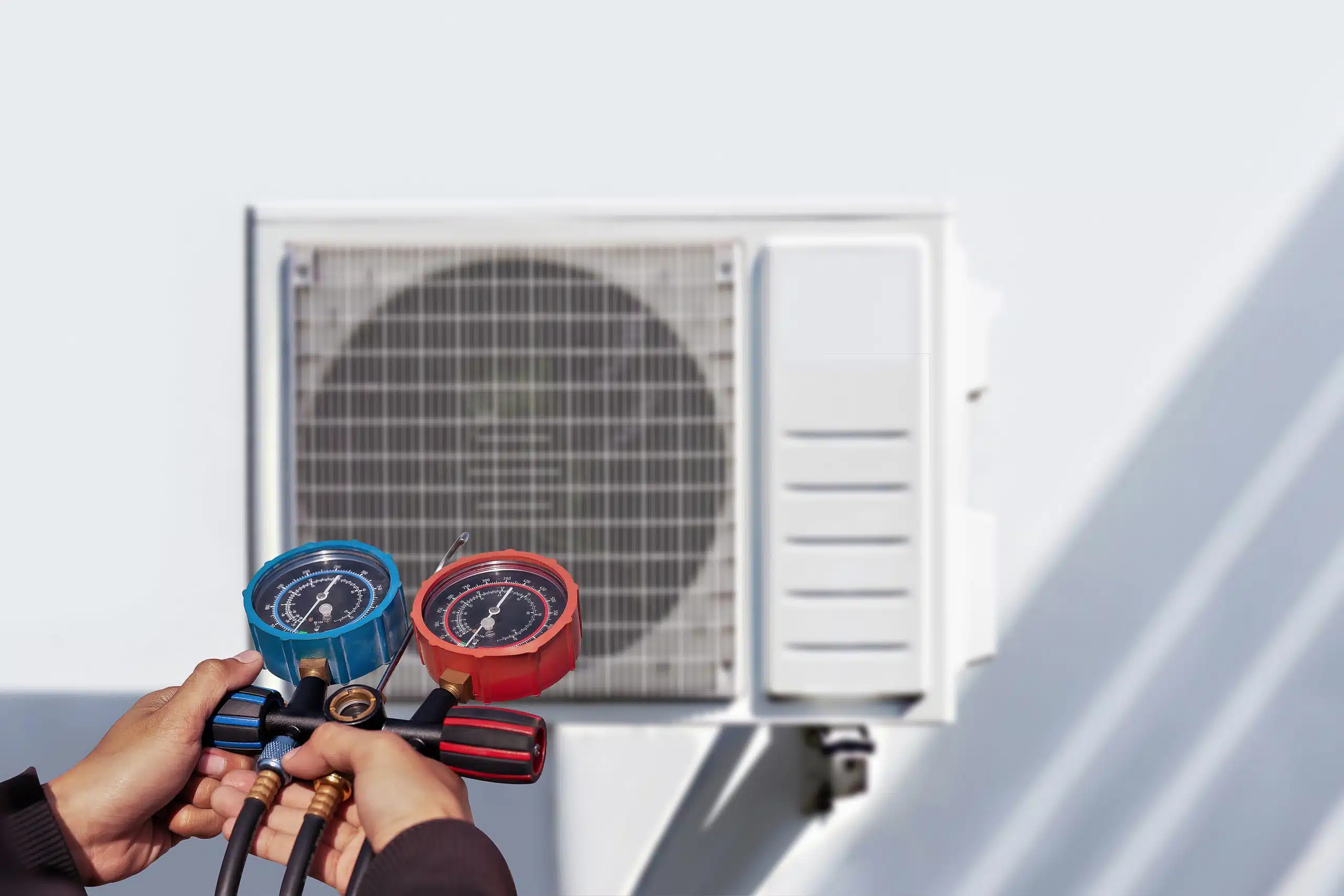 dreamstime_xxl_303244004-scaled Technician adjusting air conditioner pressure gauges.