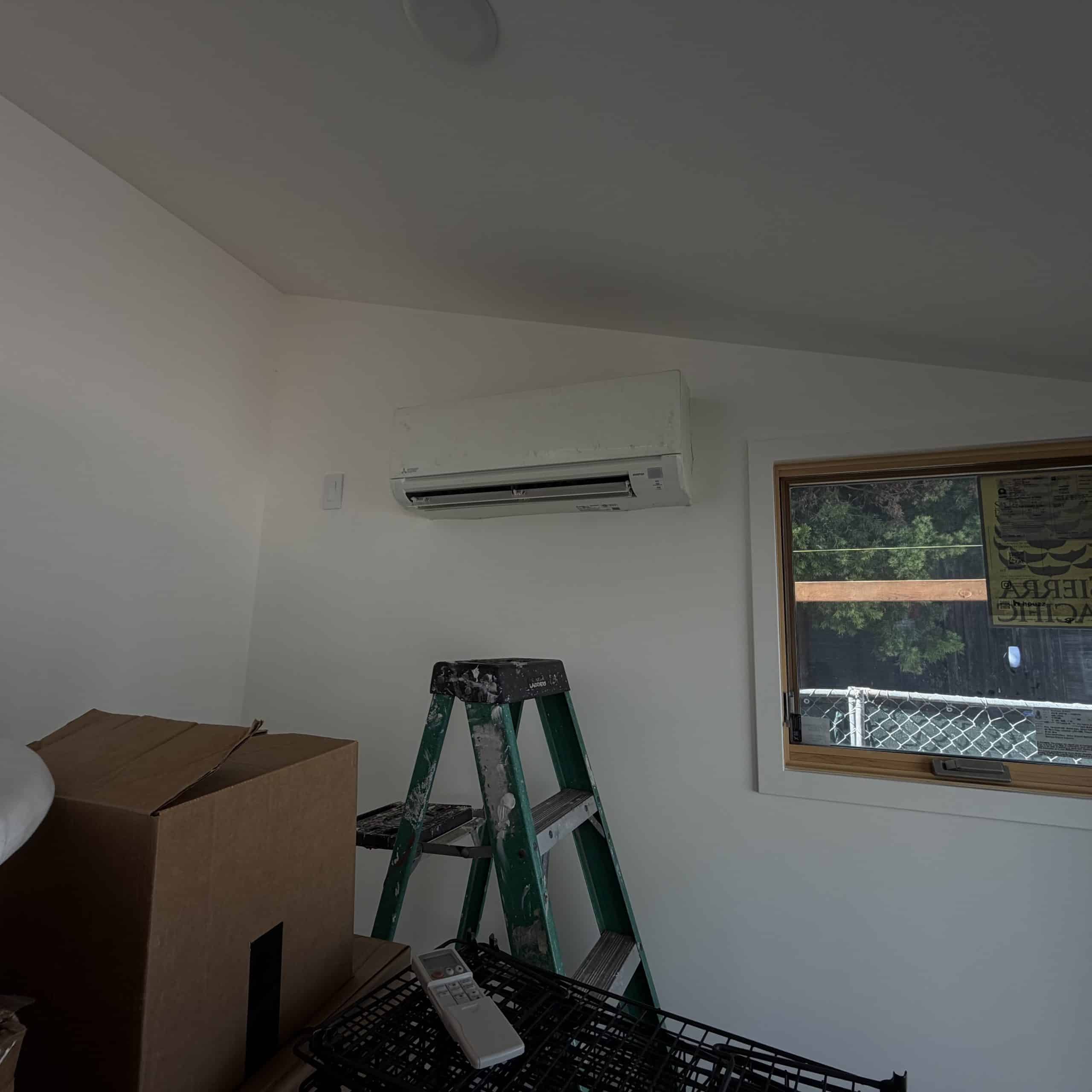 Room with air conditioner and ladder by window