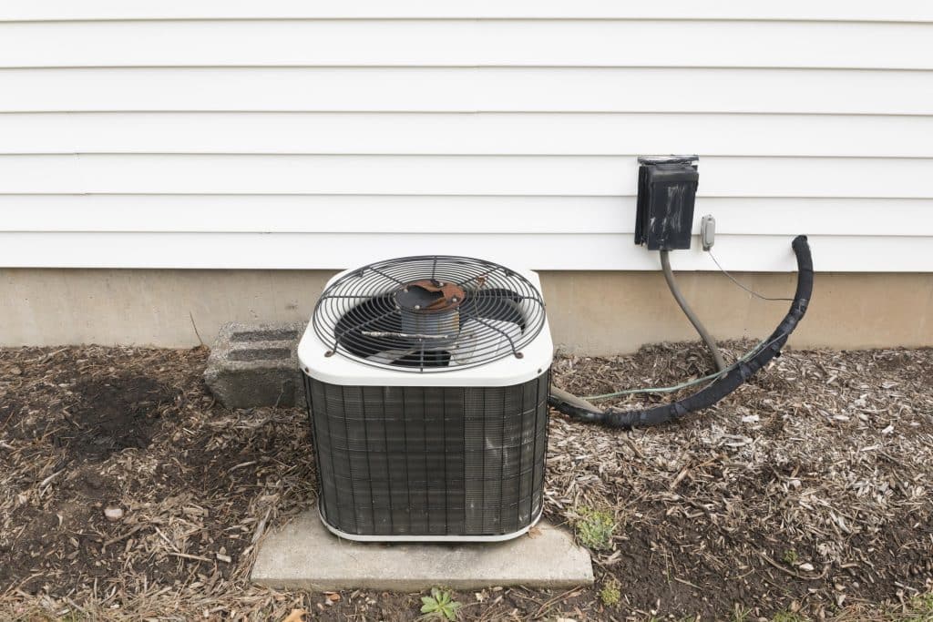 Outdoor air conditioning unit near house wall