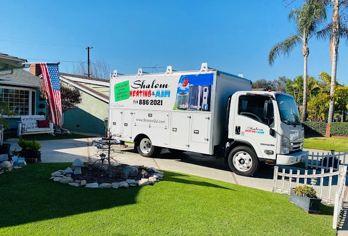 Shalom Heating & Air service truck in driveway