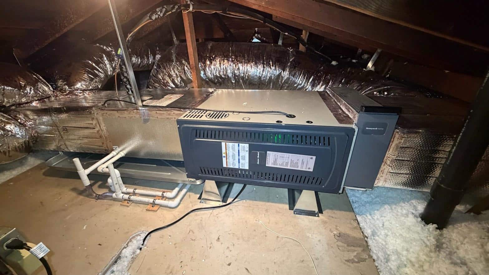 New American Standard gas furnace installed in Norwalk attic with flex ductwork and PVC condensate drain lines