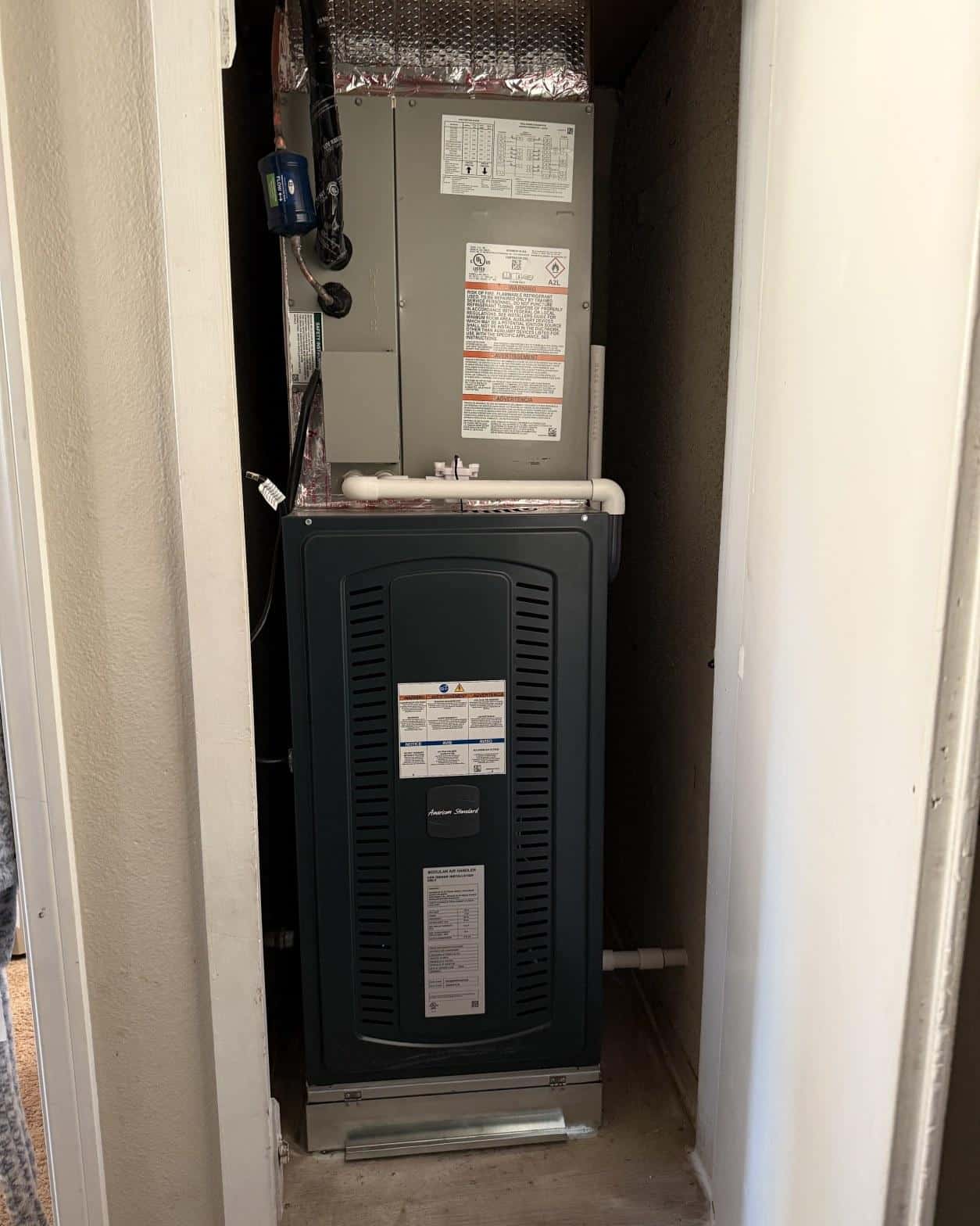 American Standard modular air handler and evaporator coil installed vertically in a residential utility closet, Carson CA