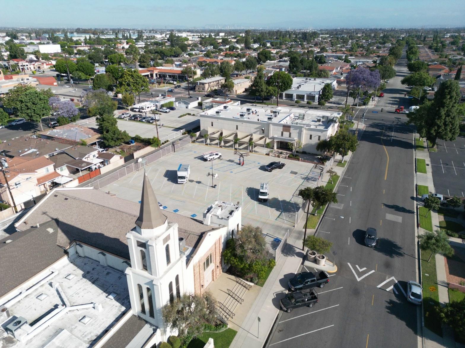Drone aerial view of large commercial church campus in Paramount CA with HVAC installation underway