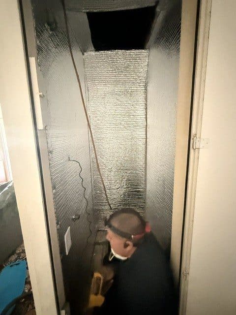 Technician servicing a commercial HVAC system on site